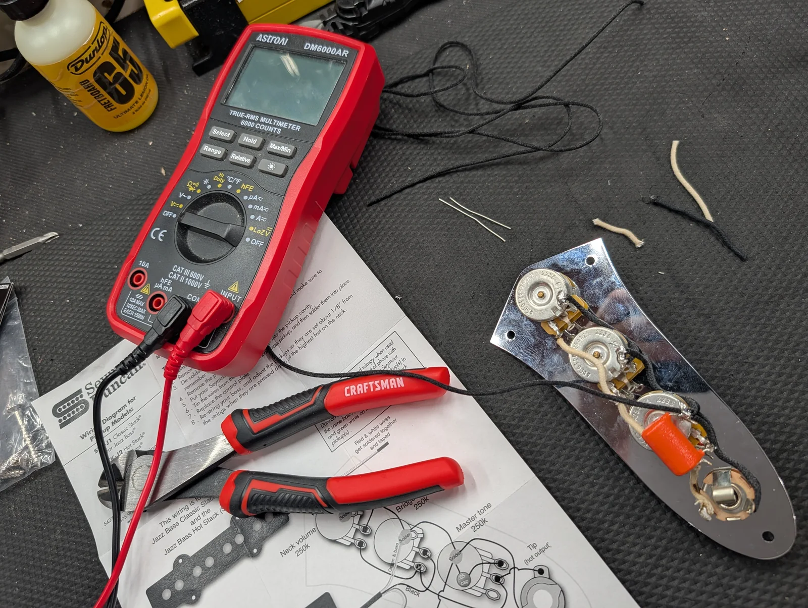 Guitar electronics being tested with a multimeter